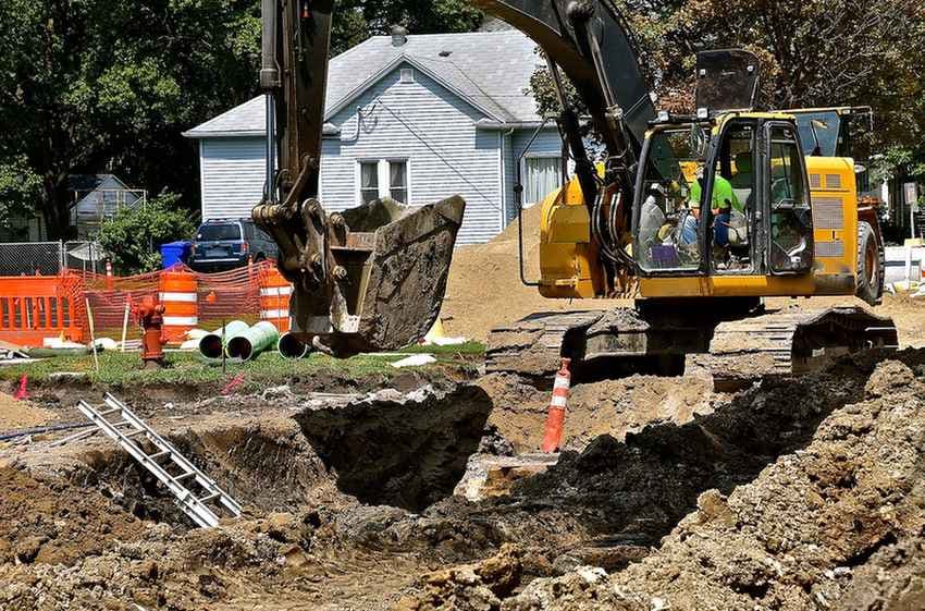 Excavating vehicle digging a trench