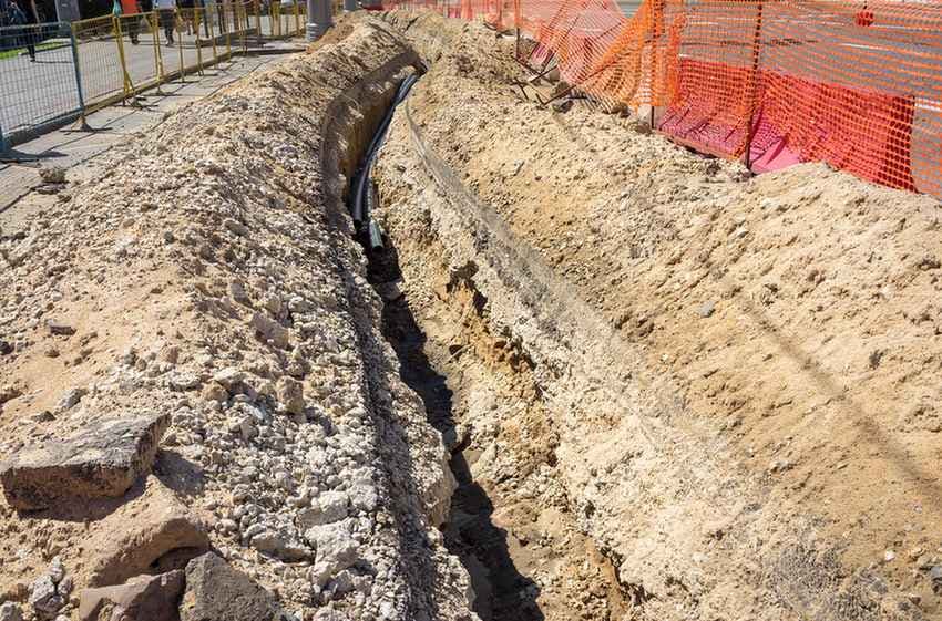 Trench with underground utility pipe